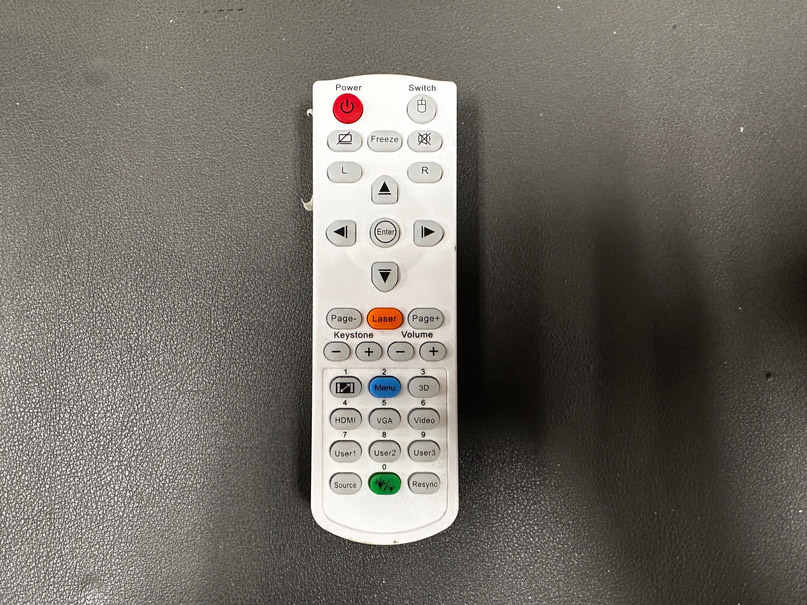 The white rear projector remote with a red Power button