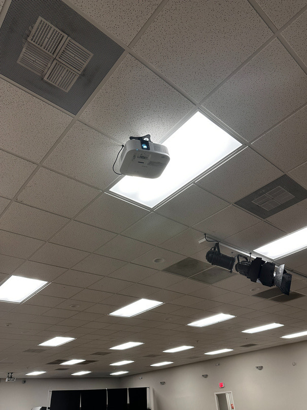 A side-screen projector mounted on the ceiling