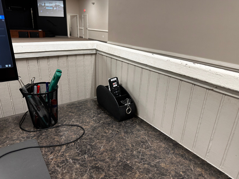 The remote caddy on the floor at the front of the room