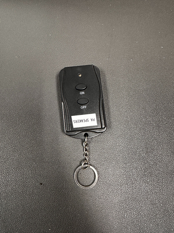 The small black remote labeled P.A. Speakers